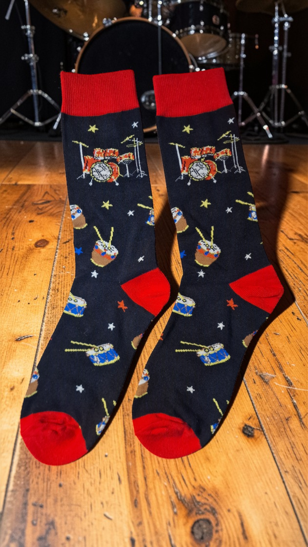 Pair of socks with musical instrument design on a wooden floor