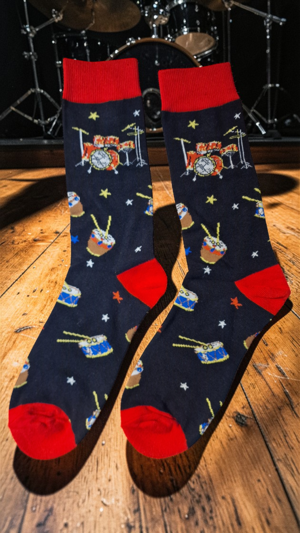 Pair of socks with drum design on a wooden floor