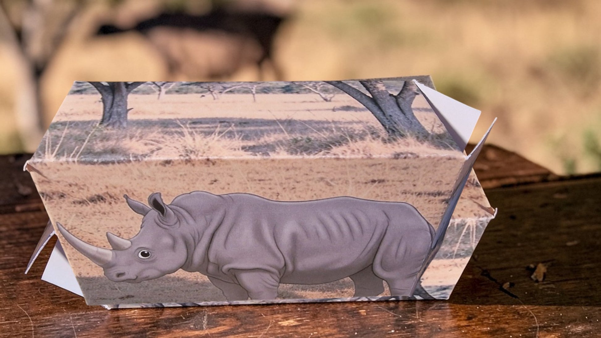 Wooden box with a rhinoceros design on a wooden surface