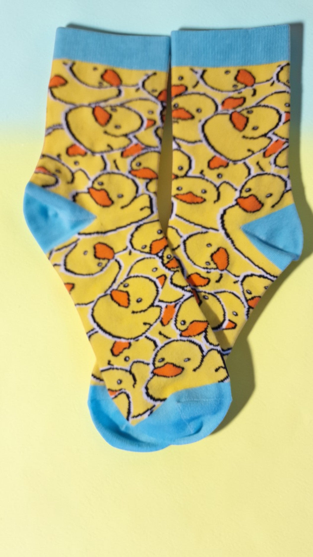 Socks with rubber duck pattern on a yellow and blue background