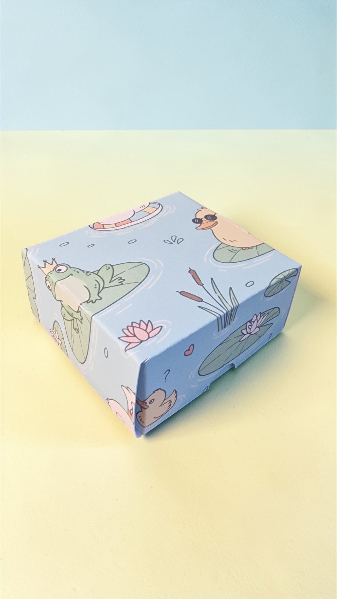 Cartoon-themed box with animals and plants on a gradient background