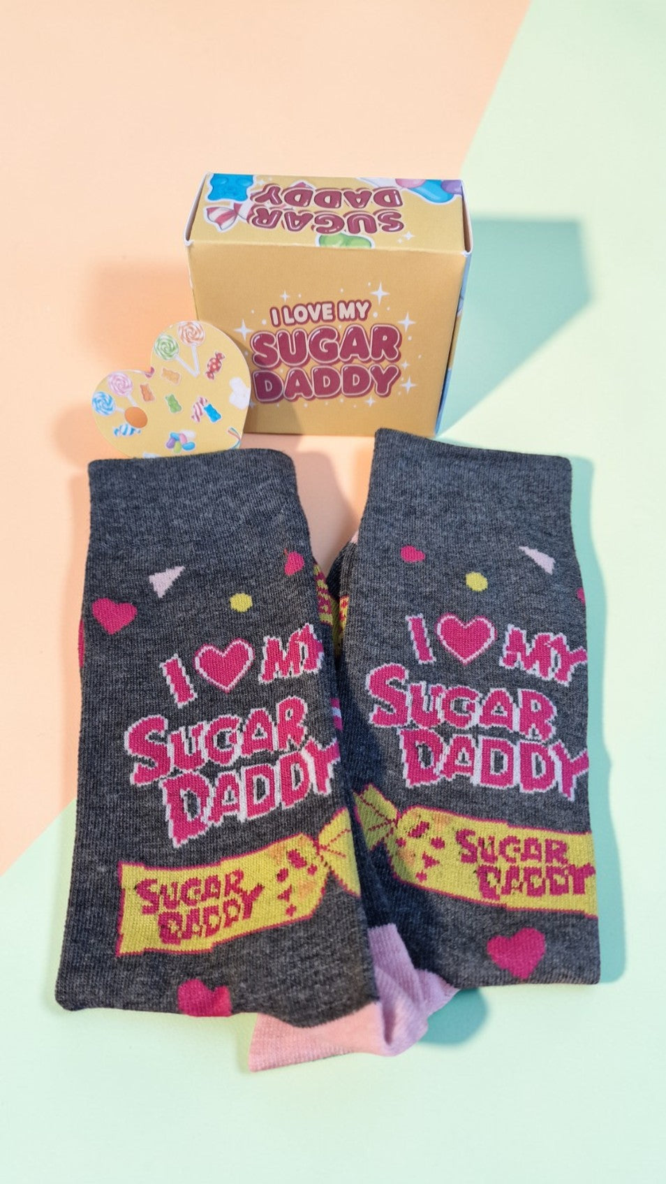 Gray socks with 'I love my sugar daddy' text on a light green background