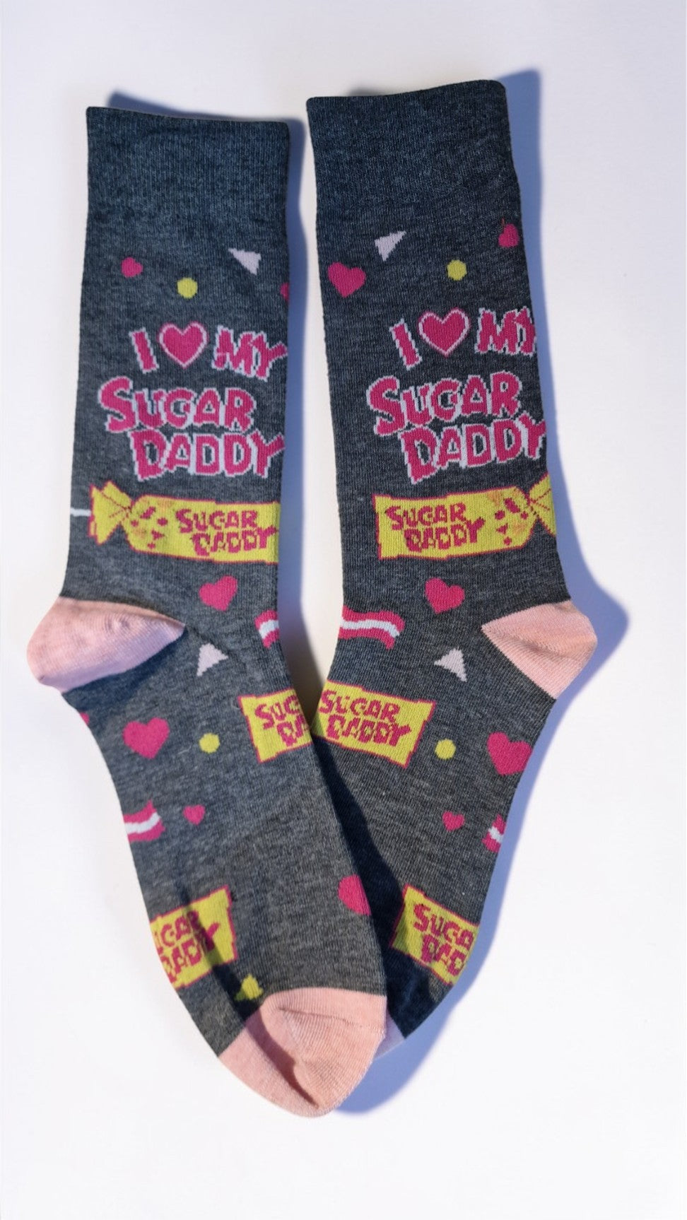 Gray socks with colorful text and graphics on a white background