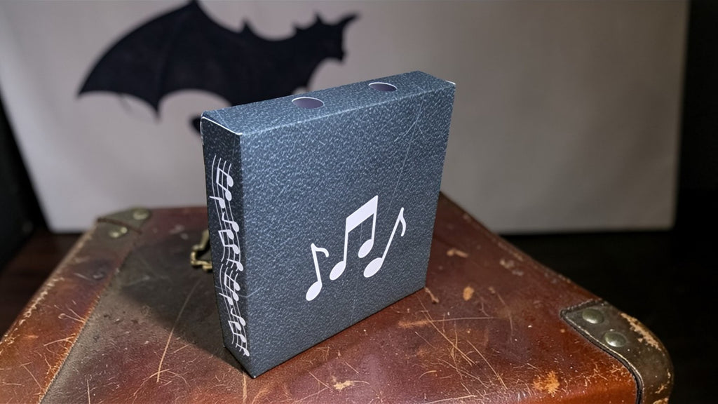 Small blue box with musical notes on a worn wooden surface