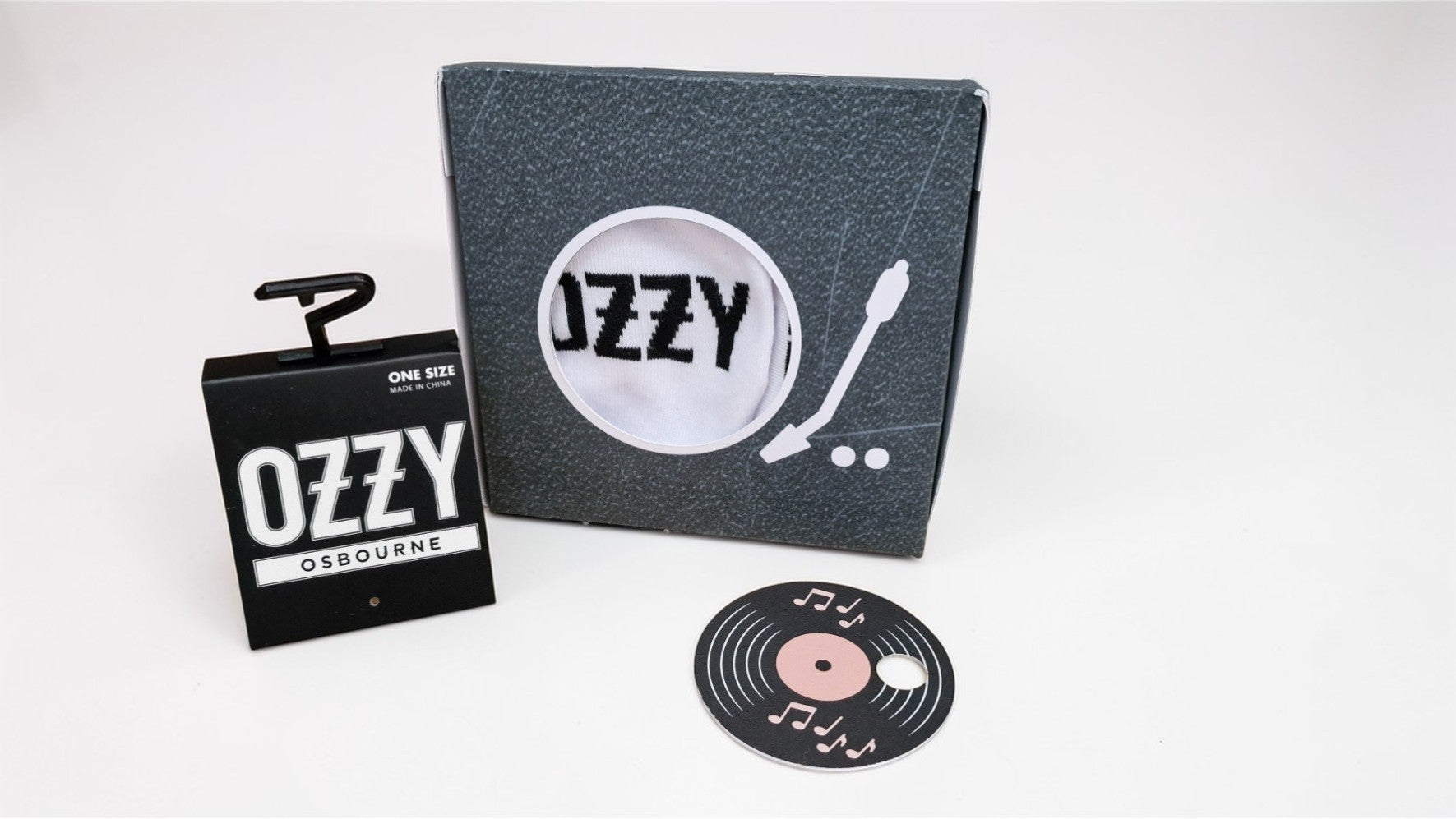 Ozzy Osbourne branded items including a notebook, coaster, and vinyl record on a white background