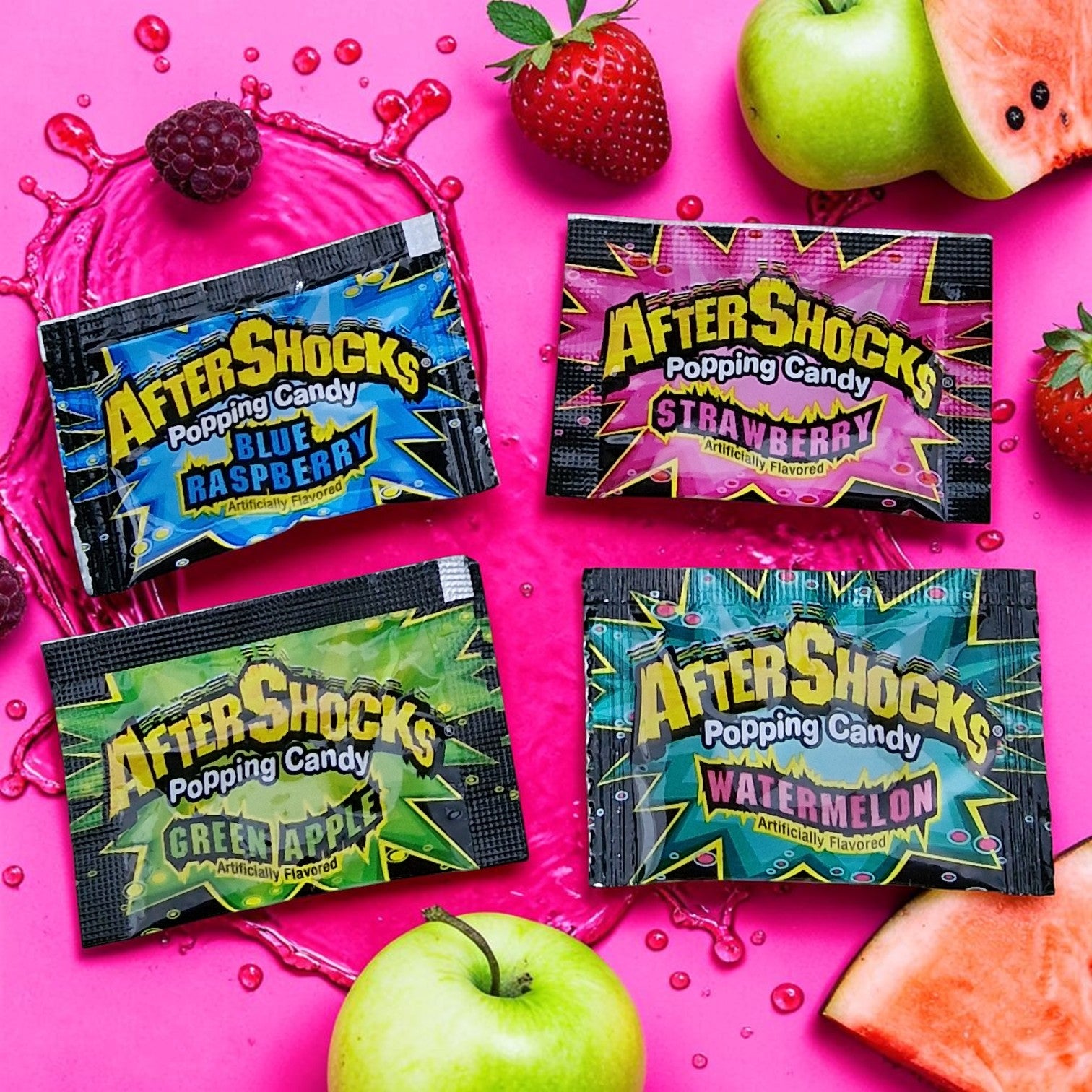 Four AfterShocks popping candy packages on a pink background with fruit.