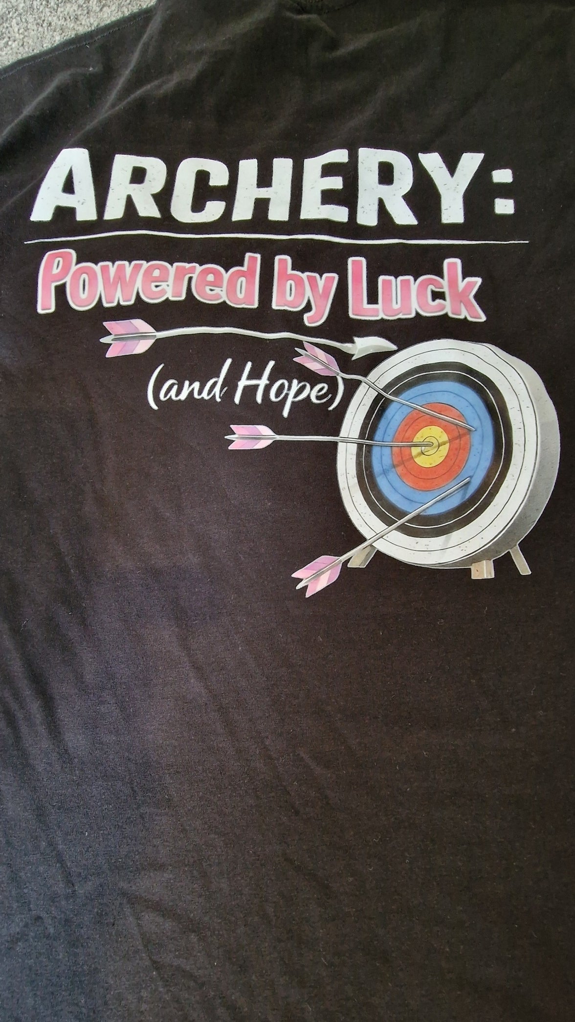 Black t-shirt with archery-themed design and text on a dark background