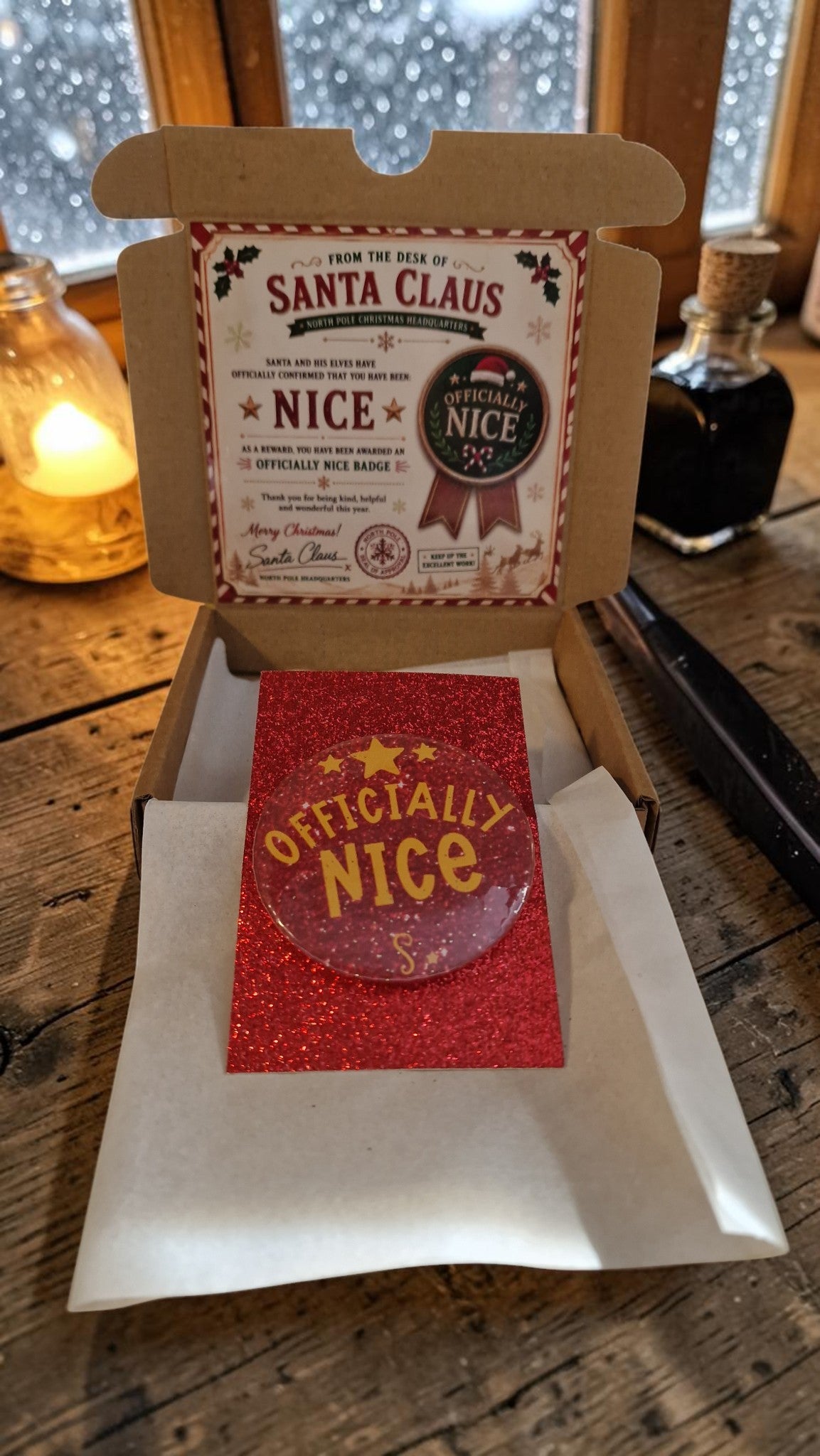 Red 'Officially Nice' card with a ribbon in a decorative box on a wooden surface.