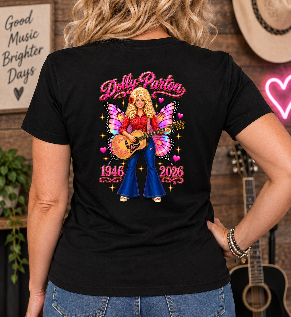 A woman viewed from behind wearing a black graphic t-shirt with a colorful Dolly Parton illustration on the back, set against a rustic country-themed background with guitars and a neon sign.