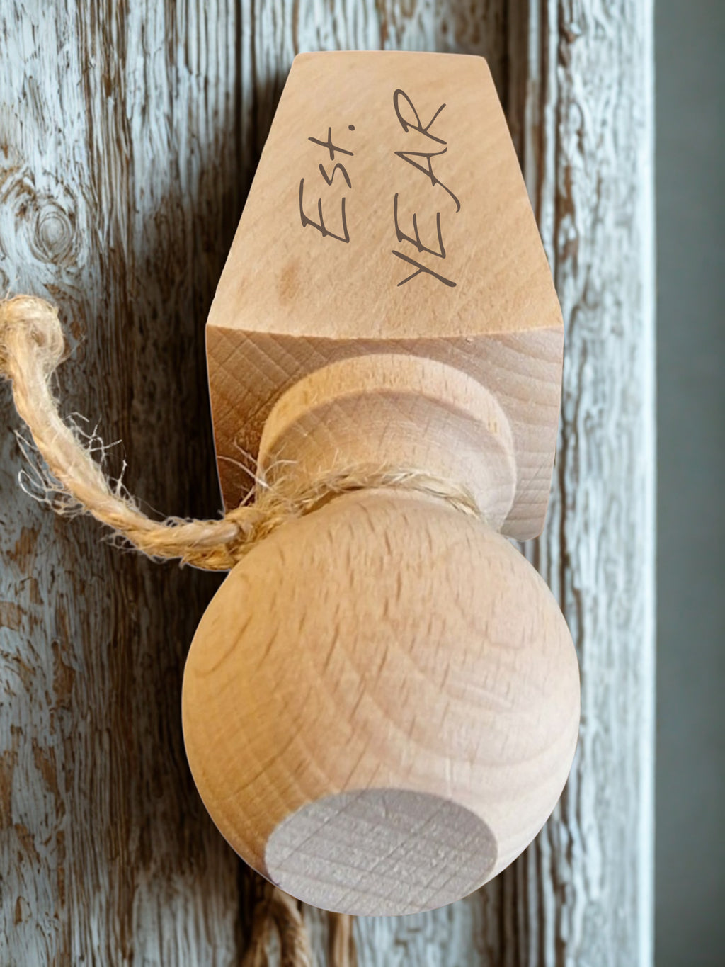 Wooden ball with a cardboard top labeled 'Est. Year' on a rustic wooden background
