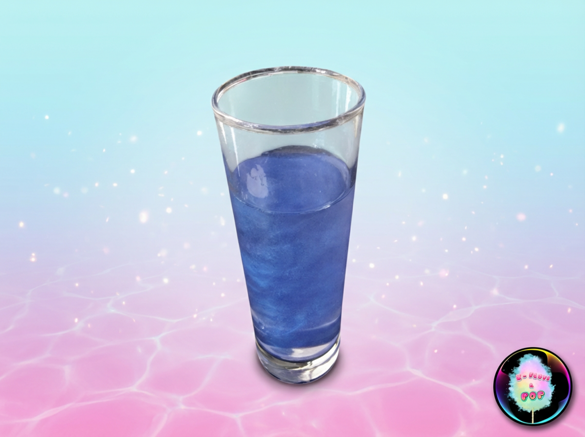 Clear glass filled with blue liquid on a gradient pink to blue background