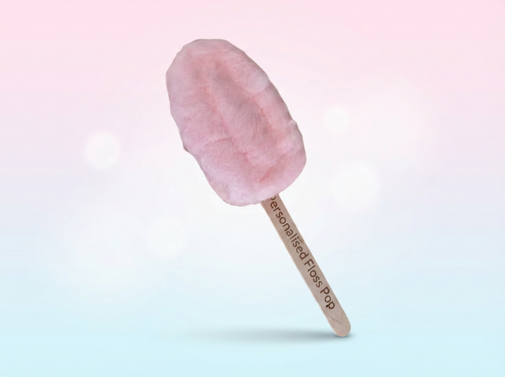 Pink cotton candy on a stick against a gradient background
