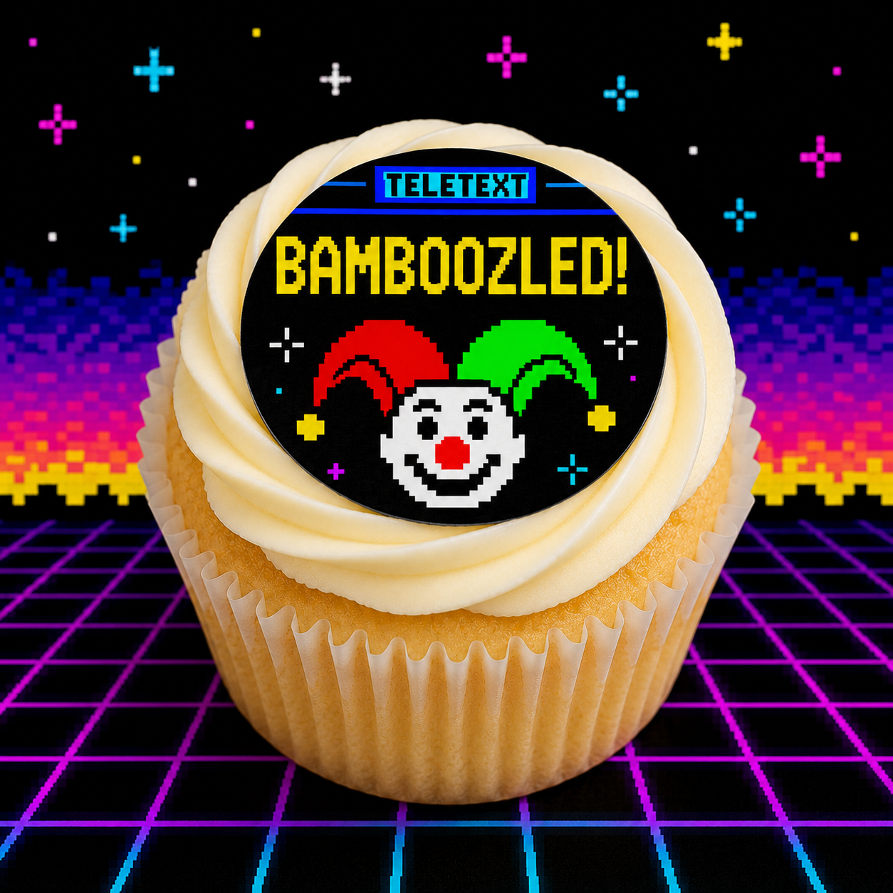 Cupcake with a 'Teletext Bamboozled!' topper on a retro grid background