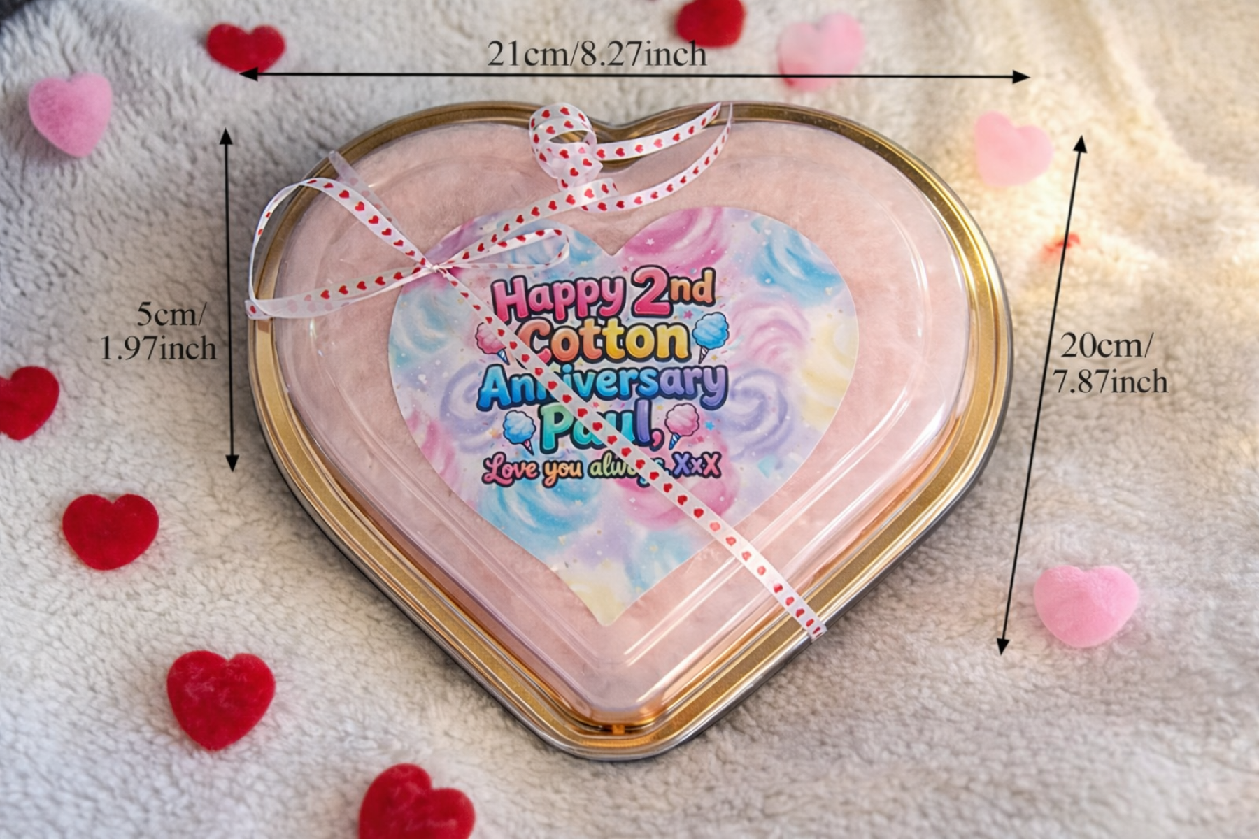 Heart-shaped tin with a colorful card inside, surrounded by red hearts and measurement markings.