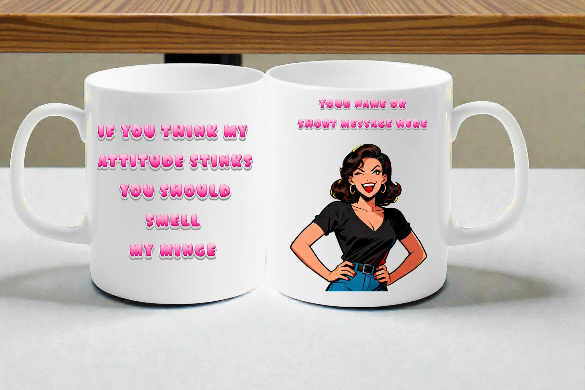 Two white mugs with a graphic of a woman and text on a table.