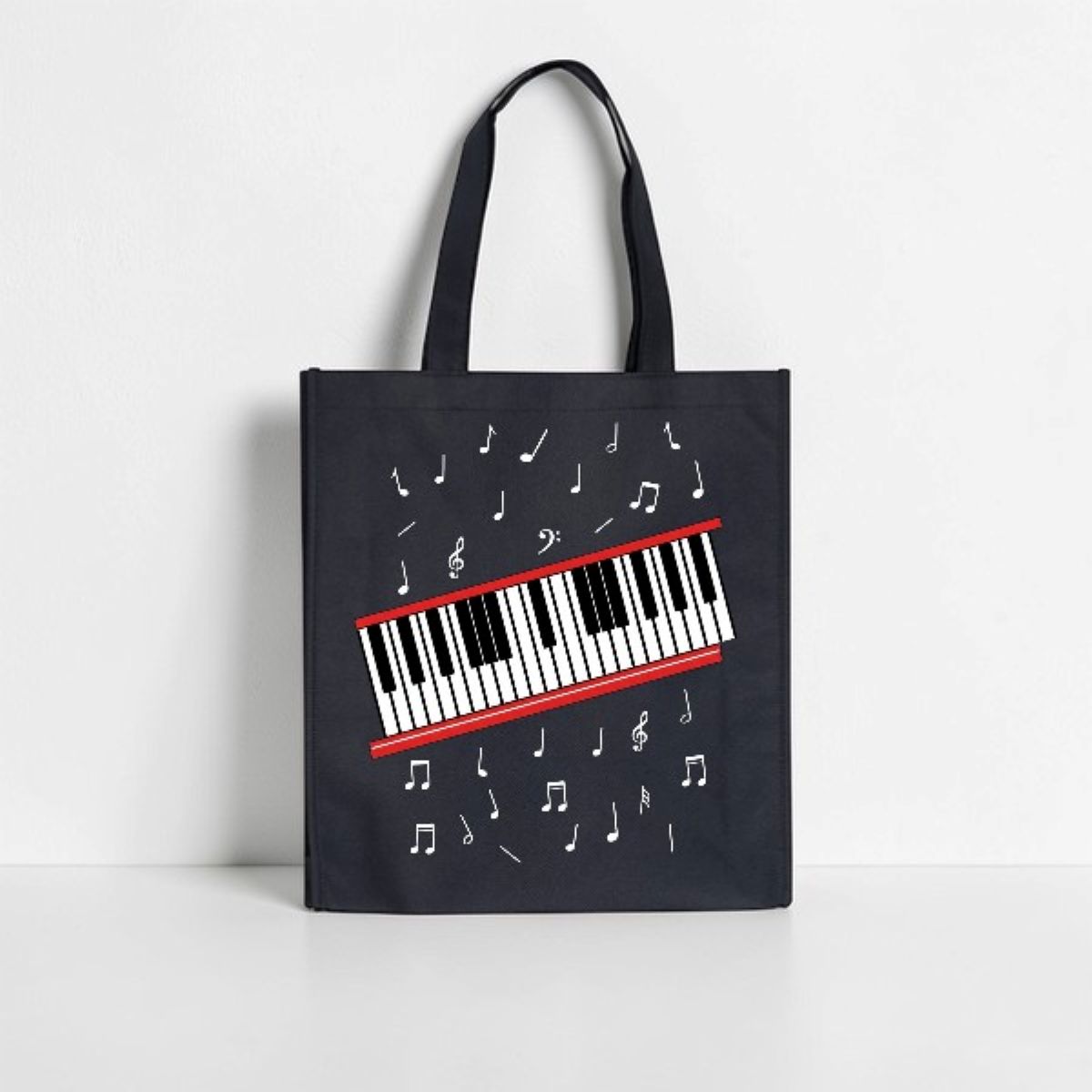 Black tote bag with a piano keyboard design on a white background