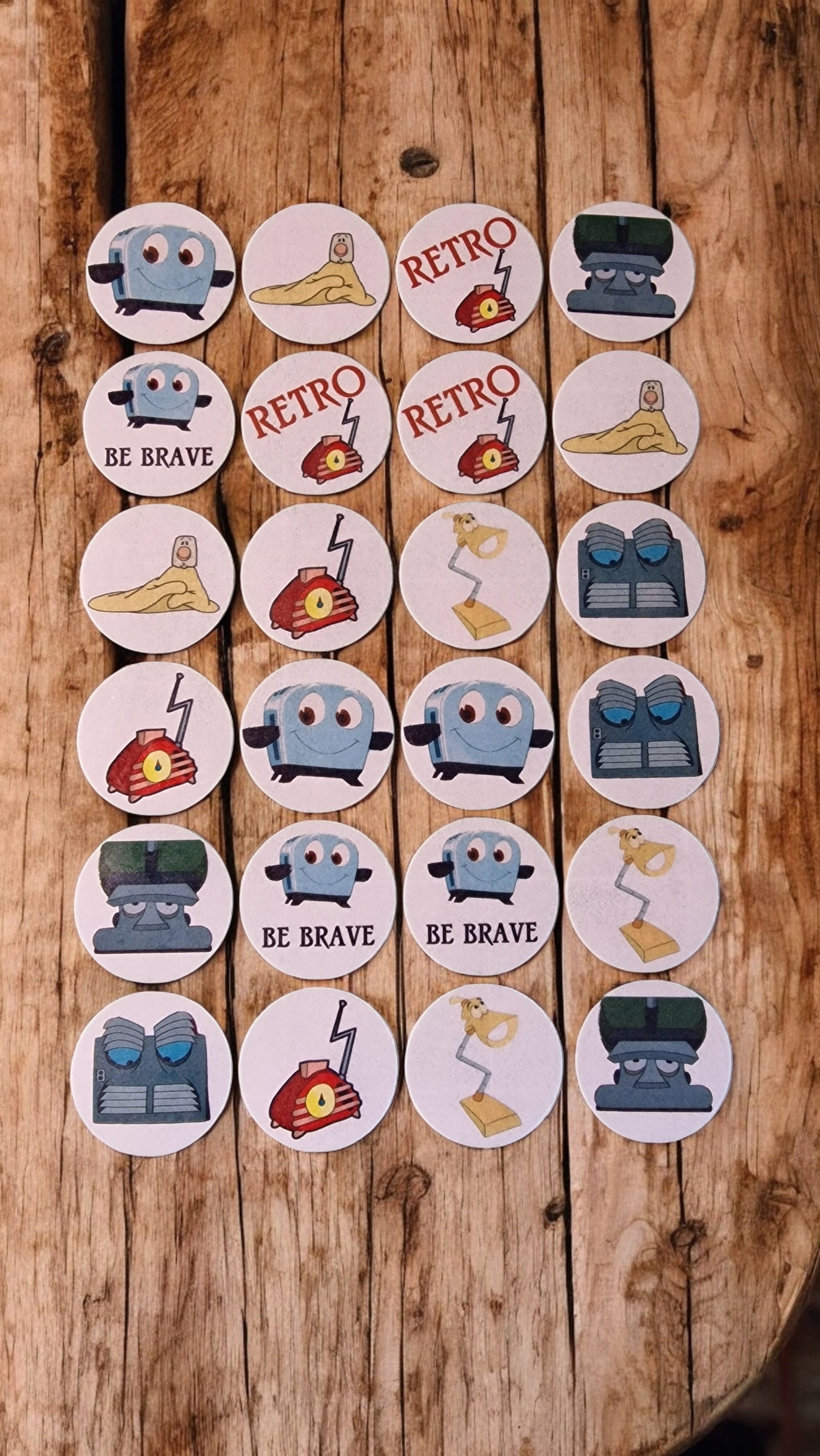 Set of round stickers with various designs and text on a wooden surface
