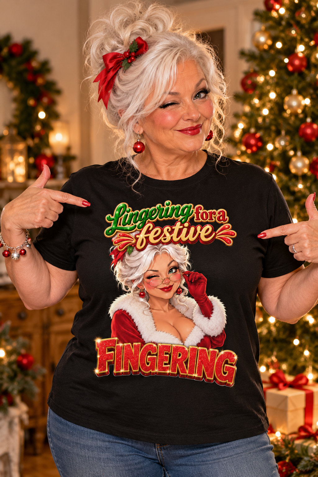 A woman with white hair in a messy bun and a red bow points at a black graphic t-shirt. The shirt features a festive graphic with the text 'Lingering for a festive FINGERING' and an illustration of a woman in a Santa hat.