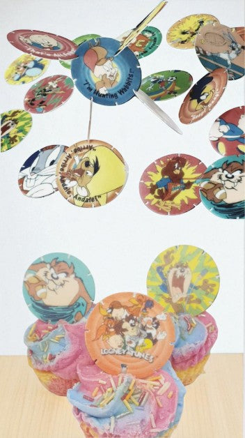 Colorful cupcake toppers with cartoon characters on a white background