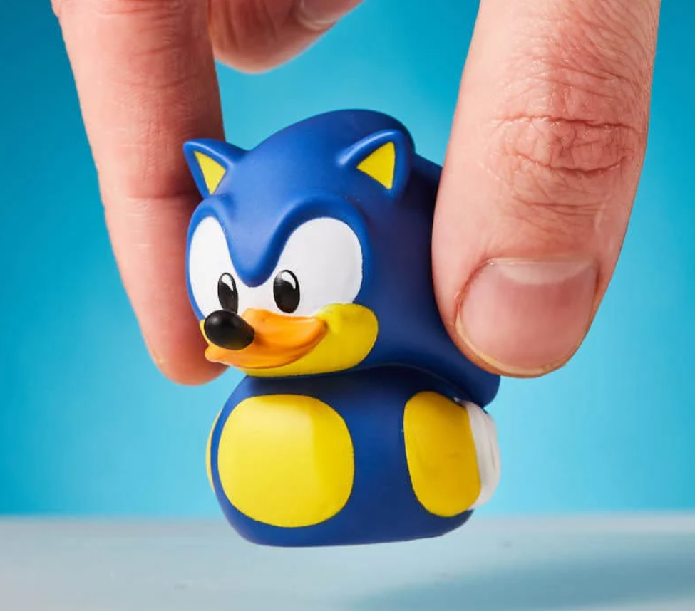 Small blue and yellow figurine resembling a character with a blue background