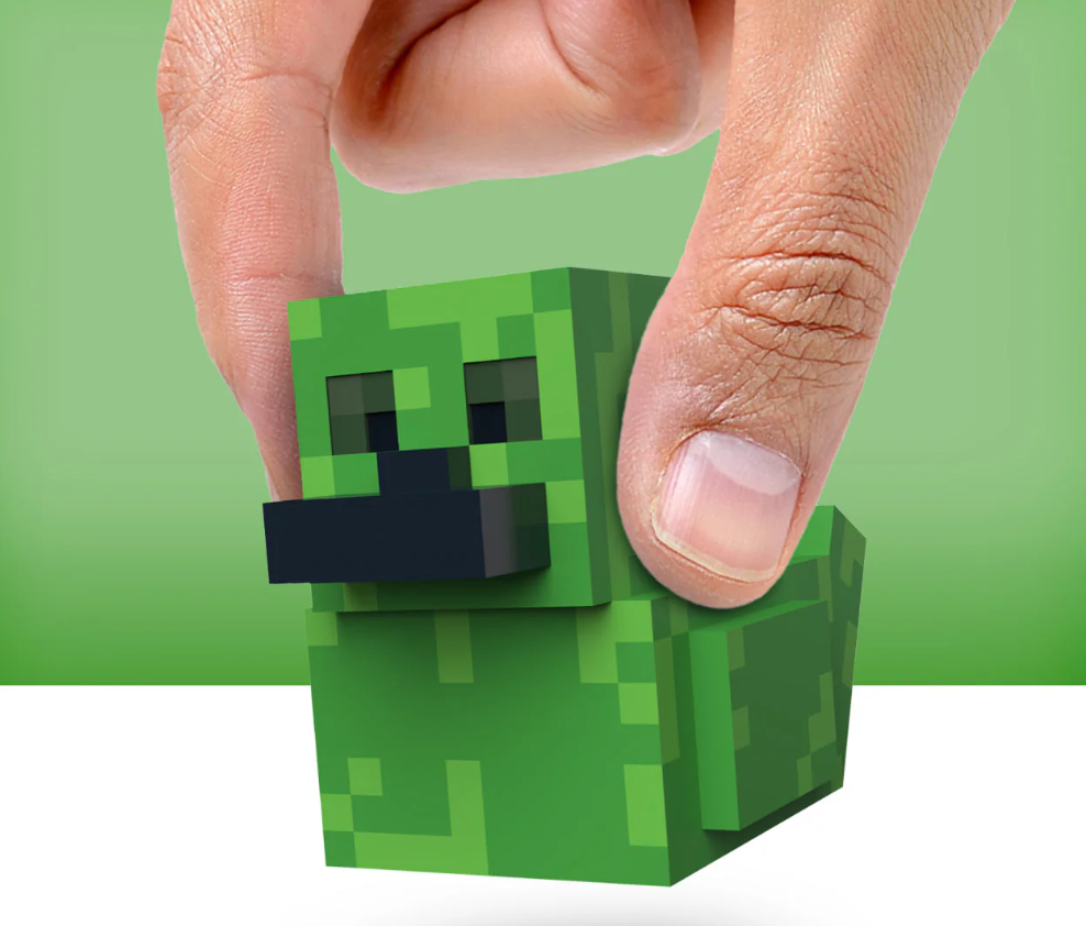 Green pixelated character held by a hand against a green background
