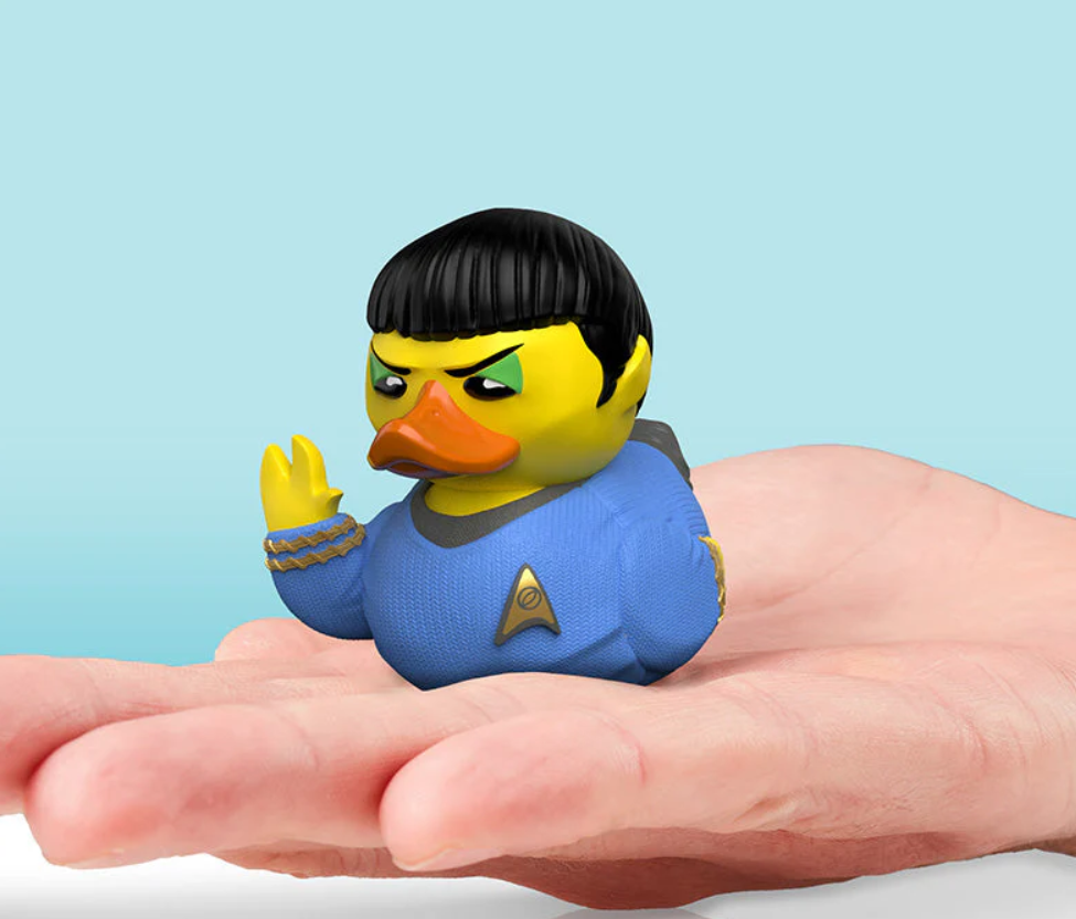 Rubber duck resembling a character from Star Trek on a hand with a light blue background