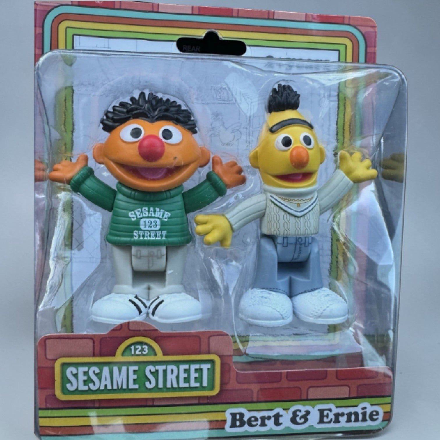 Sesame Street figures Bert and Ernie in packaging on a white background