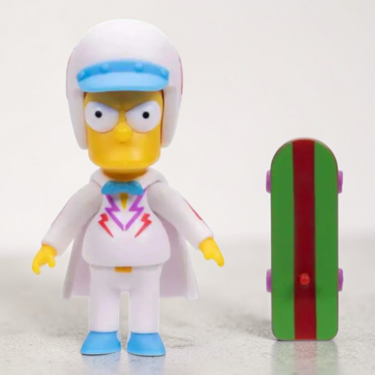 Toy figure of a character from 'The Simpsons' with a colorful skateboard on a white background
