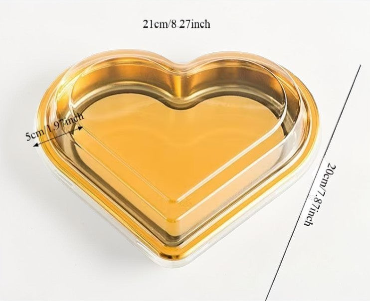 Heart-shaped gold tray with measurements on a white background
