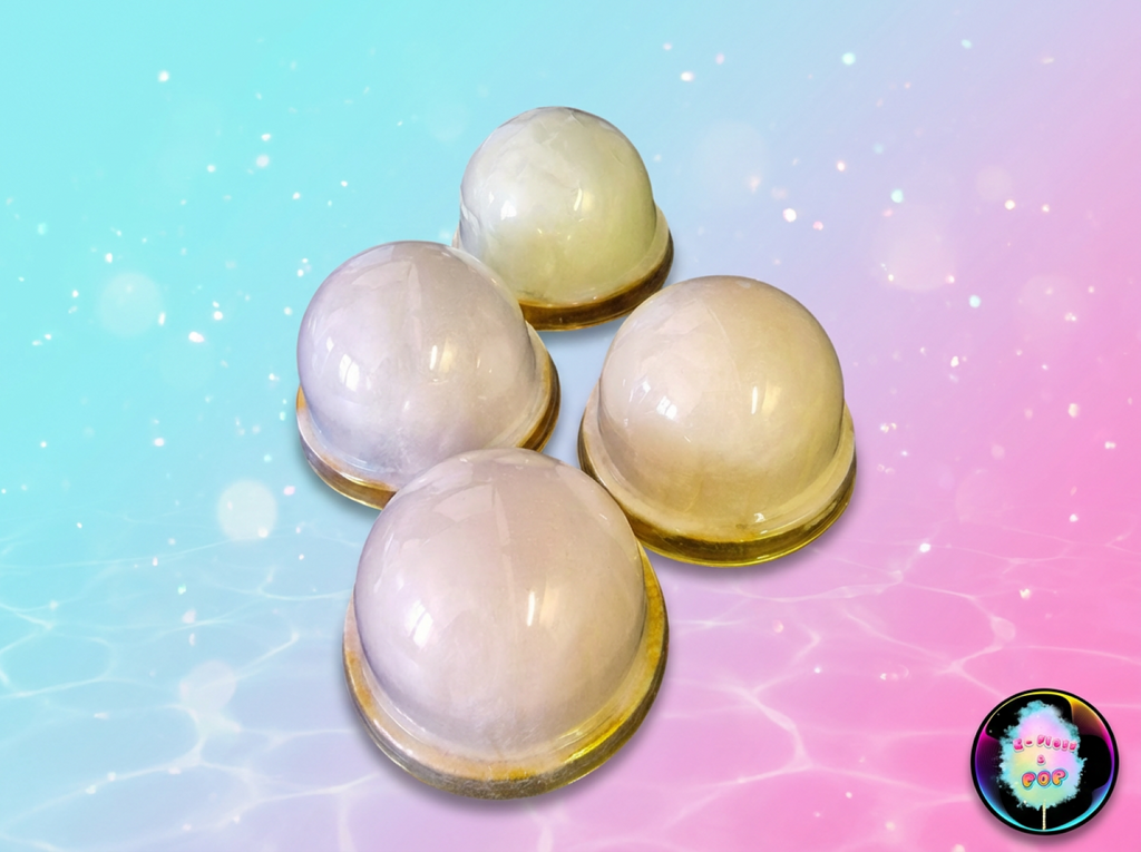 Four pastel-colored spherical objects on a gradient background