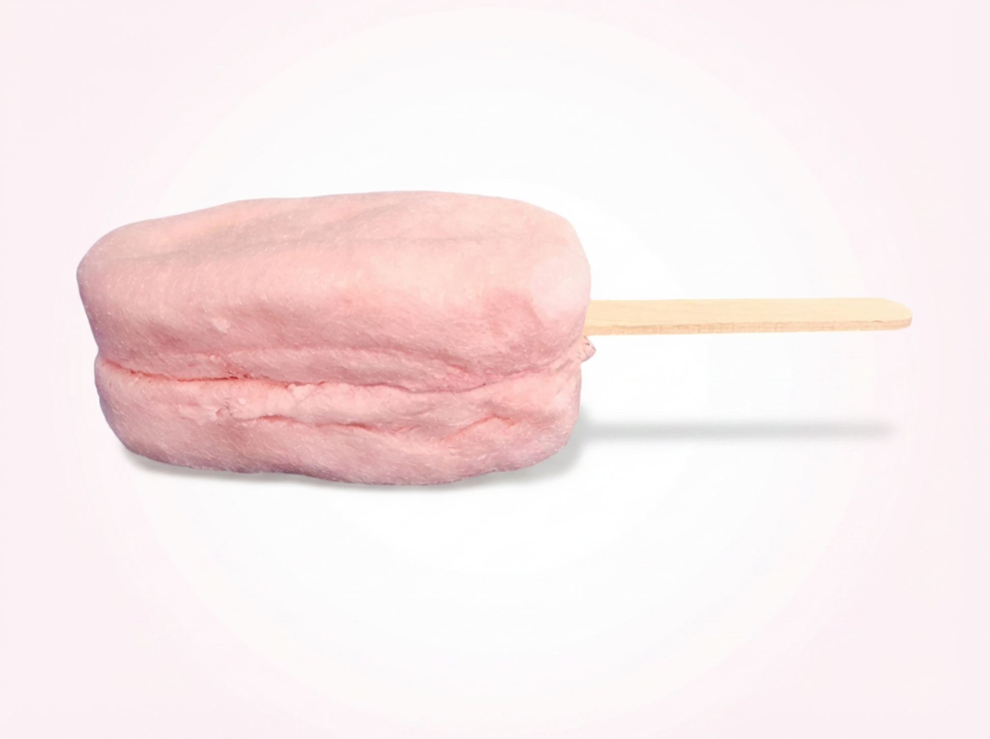Pink cotton candy on a stick against a white background