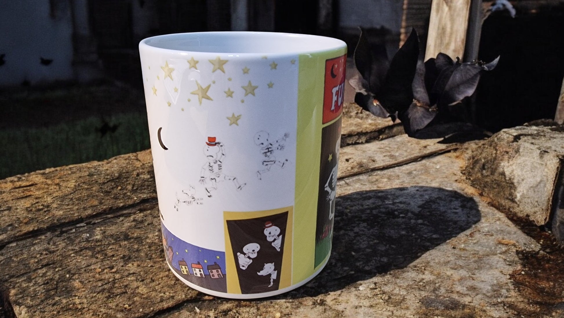 Colorful mug with illustrations on a wooden surface