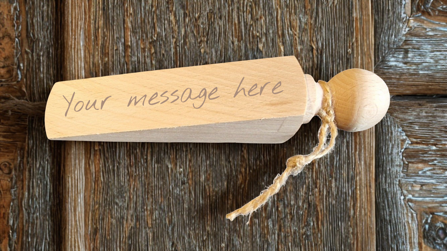 Wooden tag with 'Your message here' text on a rustic wooden surface