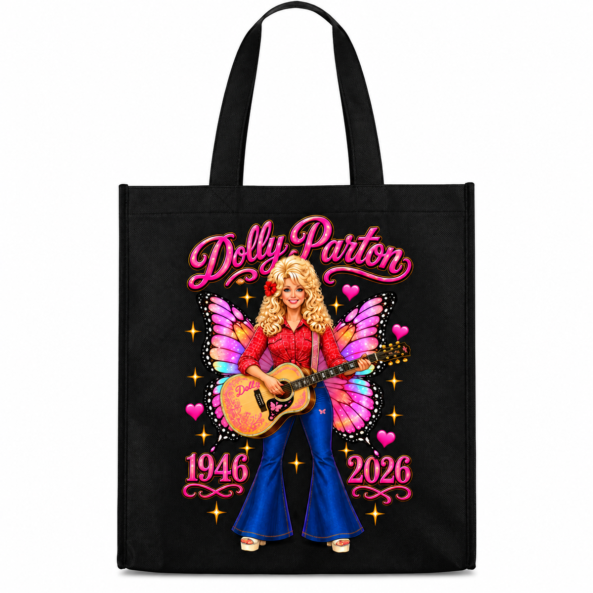 A black canvas tote bag with a colorful graphic of Dolly Parton playing an acoustic guitar, featuring pink script text reading 'Dolly Parton' and '1946 2026' on a white background.
