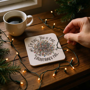 Coaster with mandala design and text on a wooden surface with coffee and lights