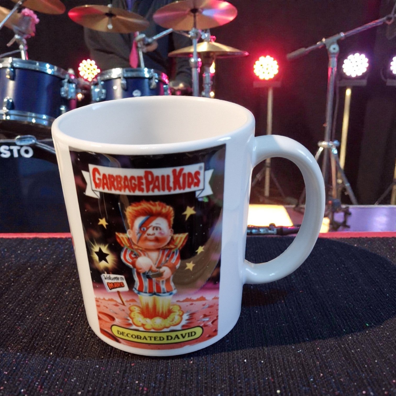 Mug with Garbage Pail Kids design on a stage background