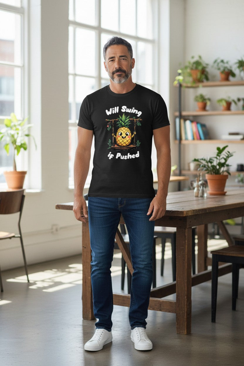 Man wearing a black t-shirt with a graphic design in a room with large windows and plants.