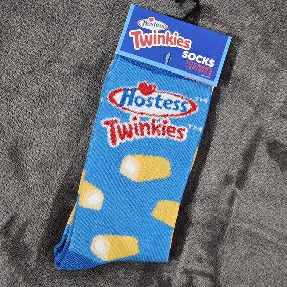 Blue socks with Twinkies design and Hostess branding on a gray surface