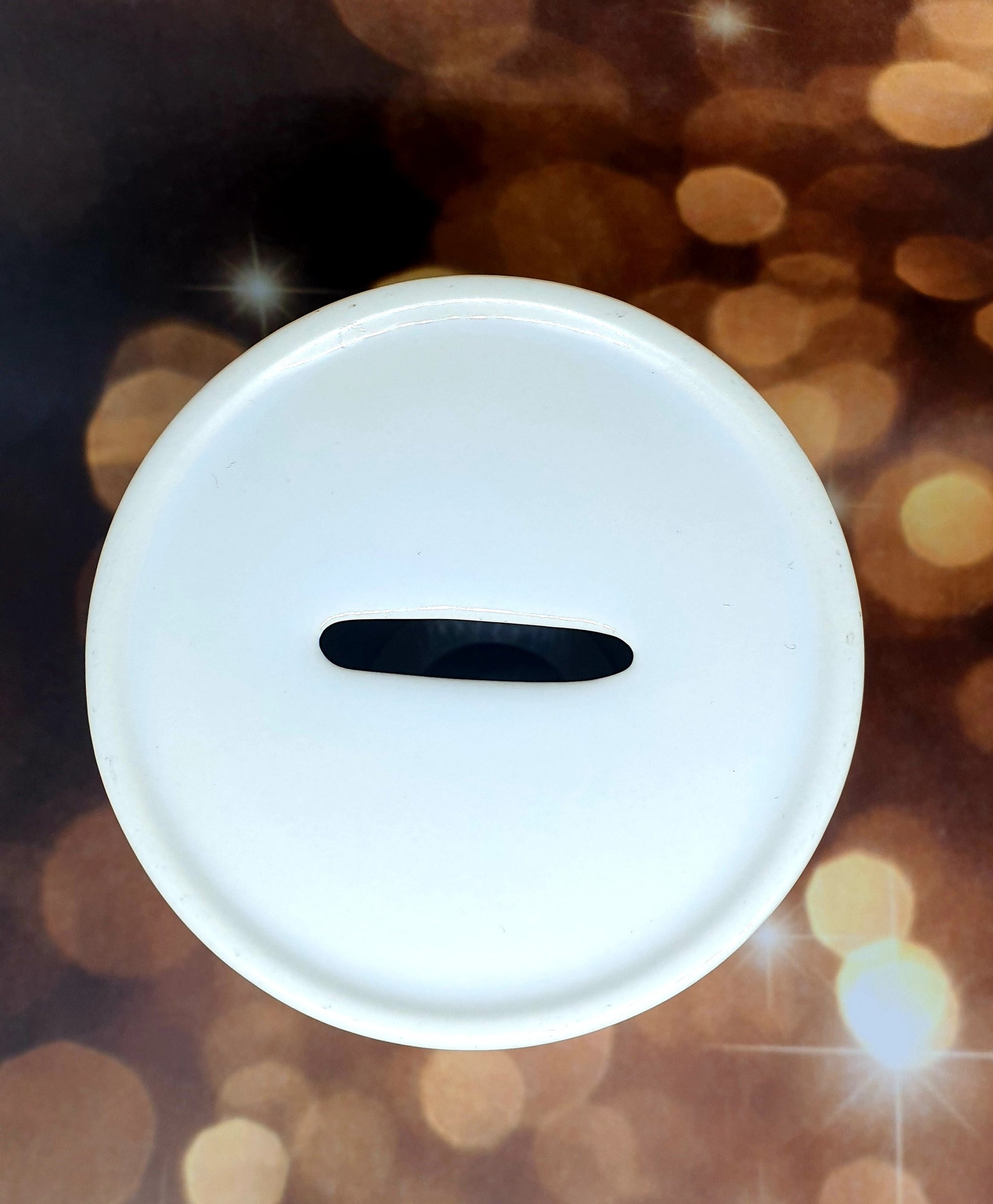 Premium glossy ceramic money box with personalised name, featuring a white rubber plug underneath and a coin slot on top.