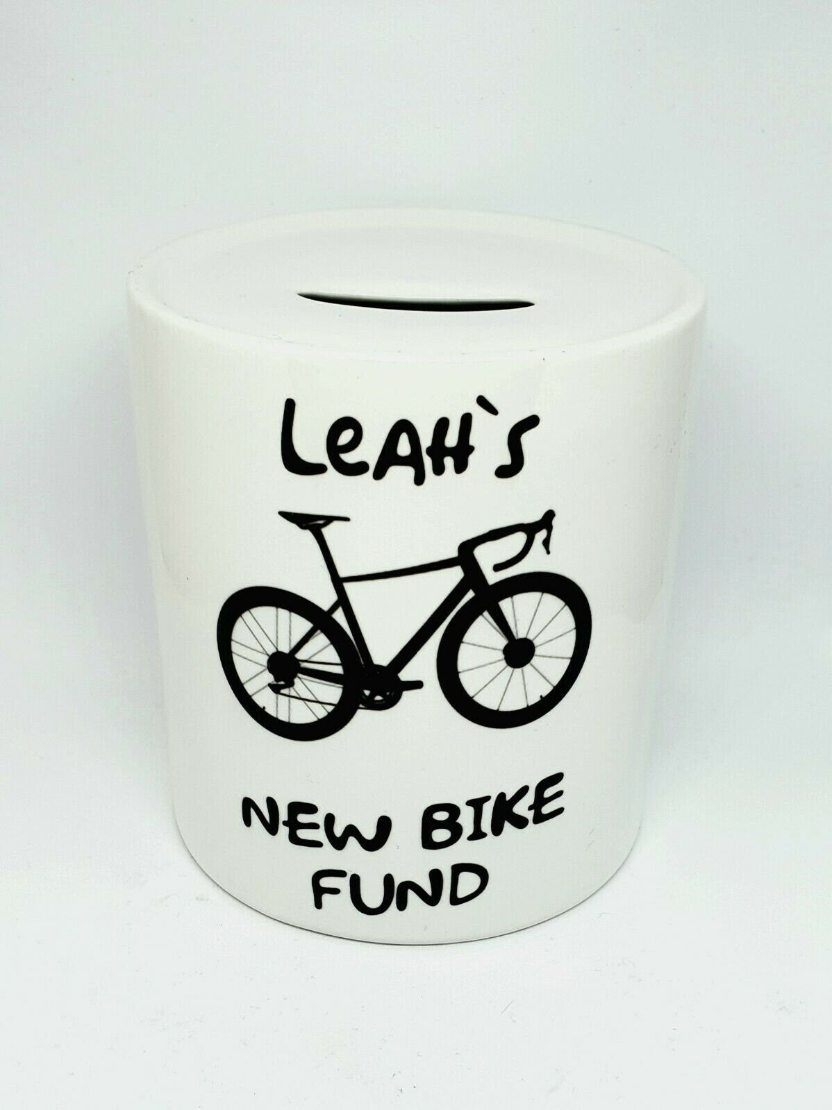 Personalised ceramic cycling money box for bike or ebike fund, with removable plug and custom text, displayed as a gift for cyclists.