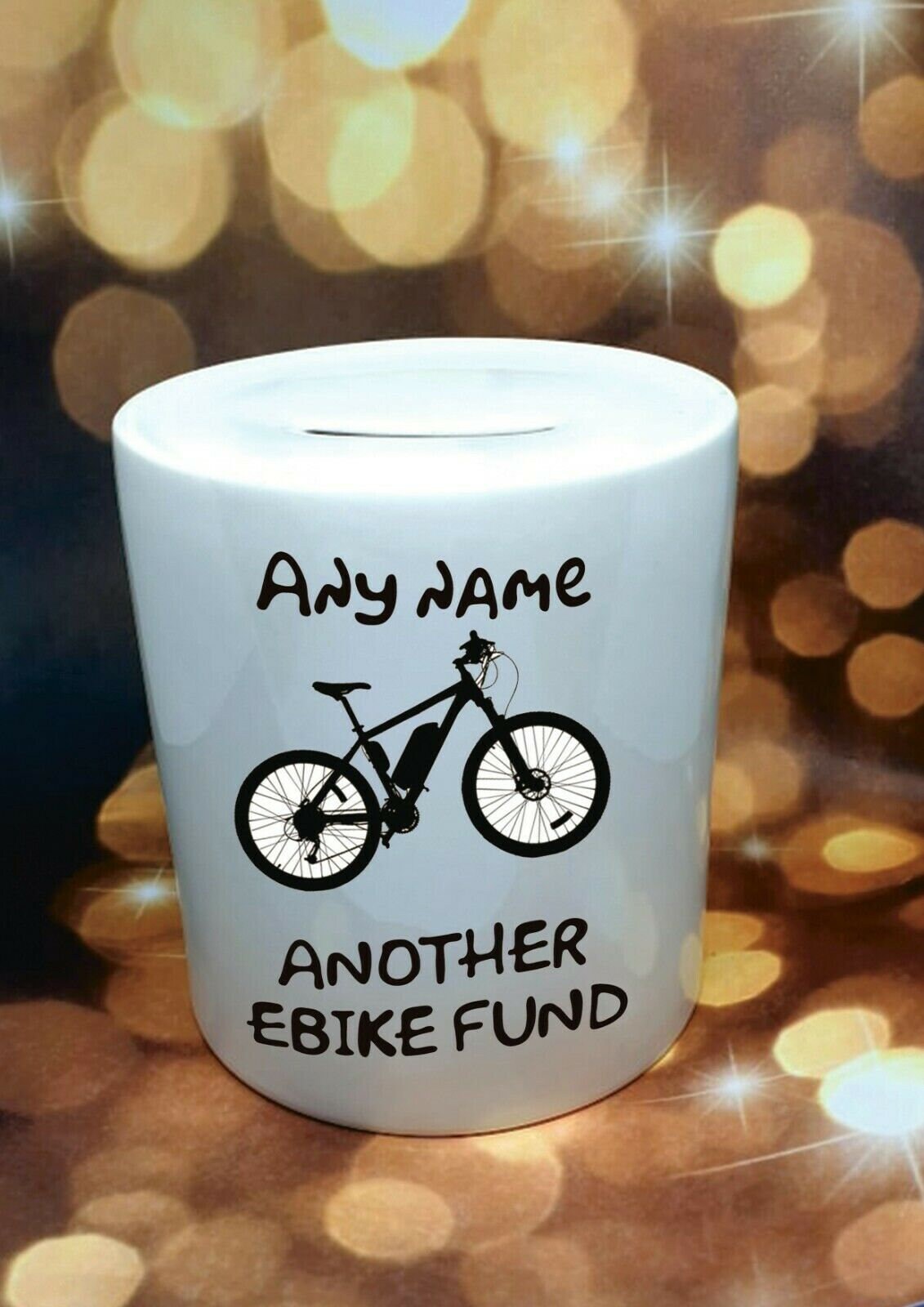 Personalised ceramic cycling money box for bike or ebike fund, with removable plug and custom text, displayed as a gift for cyclists.
