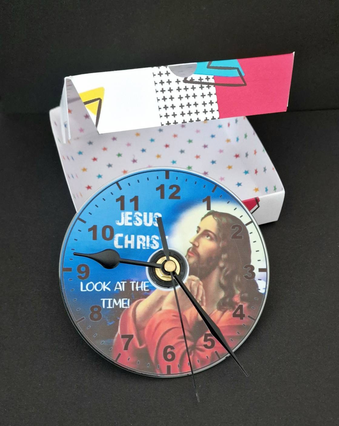 Gift boxed CD wall clock with “Jesus Christ Look at the Time” design, displayed as a unique and humorous home decor gift.