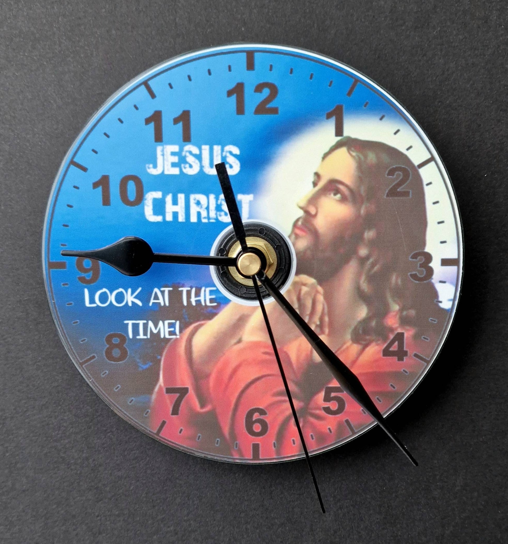 Gift boxed CD wall clock with “Jesus Christ Look at the Time” design, displayed as a unique and humorous home decor gift.