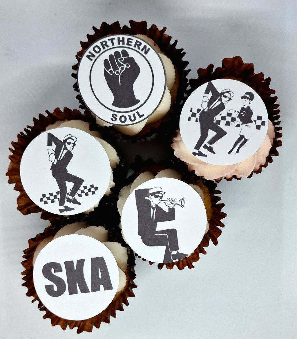 Set of 15 round and shaped edible cake toppers featuring ska hats, rude boys, checkerboards, Northern Soul fist, and 2 Tone logos, displayed on a wooden table.