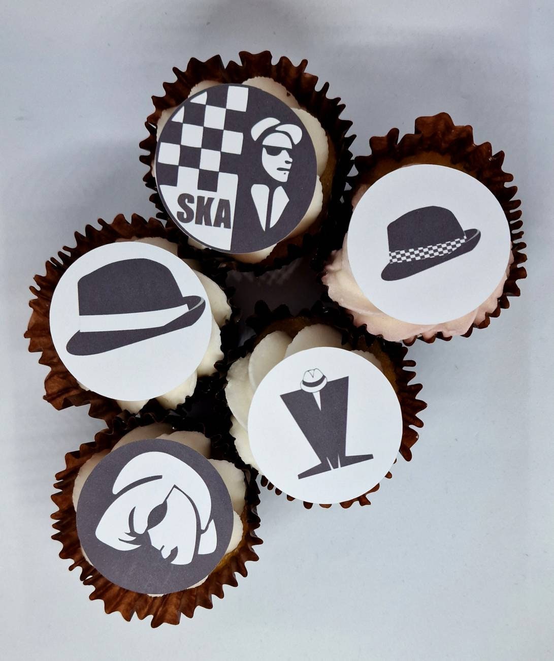 Set of 15 round and shaped edible cake toppers featuring ska hats, rude boys, checkerboards, Northern Soul fist, and 2 Tone logos, displayed on a wooden table.
