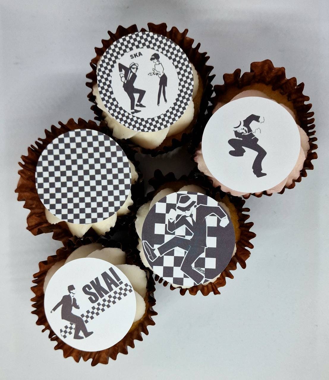 Set of 15 round and shaped edible cake toppers featuring ska hats, rude boys, checkerboards, Northern Soul fist, and 2 Tone logos, displayed on a wooden table.