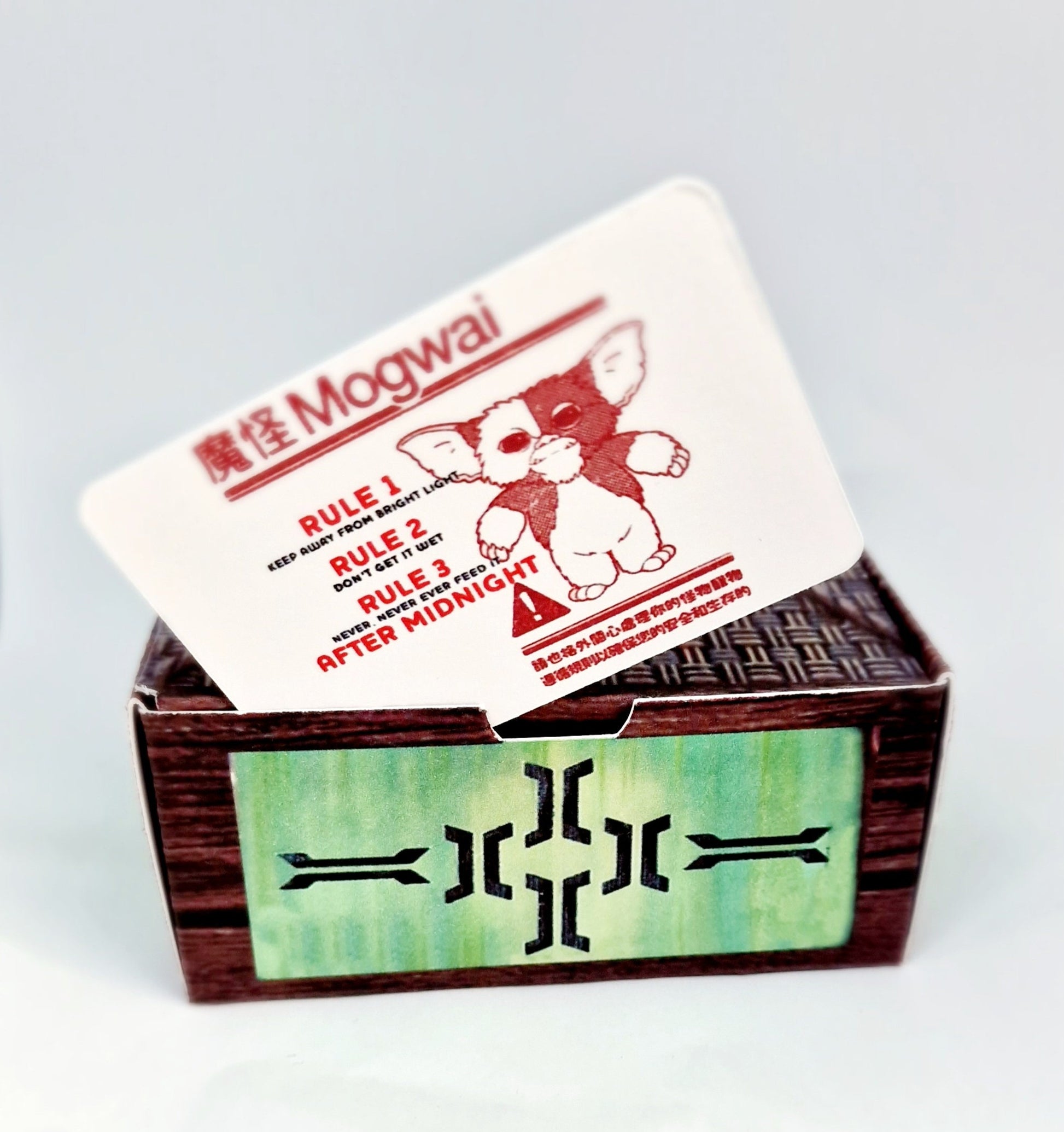 Handmade acrylic Gizmo Mogwai ornament with gift box, rule card, and free badge, displayed as a Christmas or Secret Santa gift.