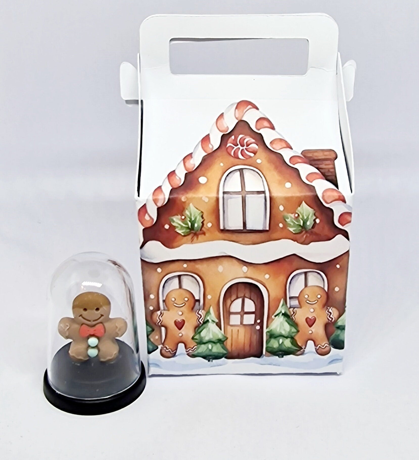 Miniature 5cm pet gingerbread man inside a small gingerbread house, displayed as a fun gift for Secret Santa or birthdays.