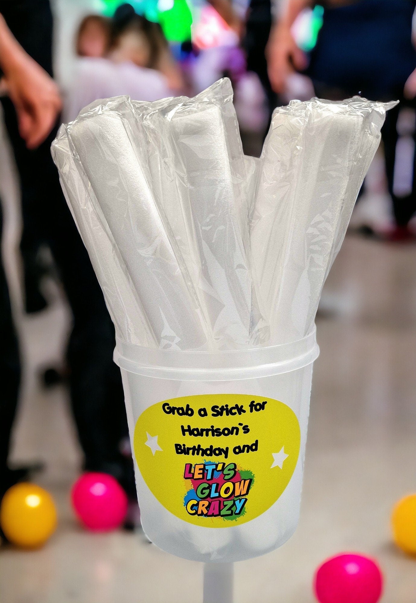 Personalised clear tub containing 10 colourful LED foam glow sticks, ideal for parties, weddings, and children’s celebrations.