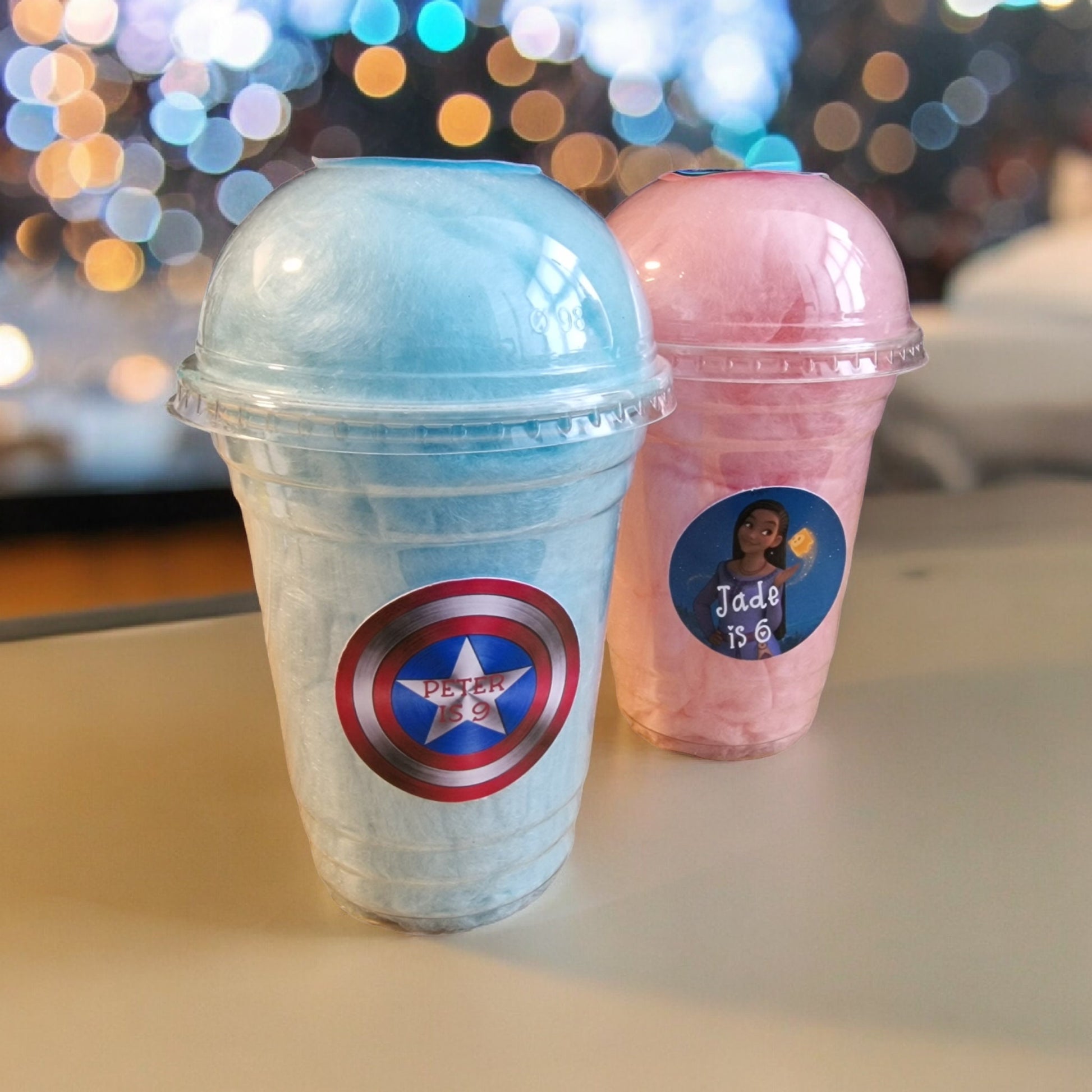 Personalised 16oz candy floss cups with lids in pink vanilla and blue raspberry flavours – perfect party favour